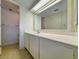 Clean bathroom features a large countertop, a mirror, and tile flooring with a shower and storage area at 645 Retreat Beach Circle, Pawleys Island, SC 29585