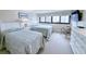 Bright bedroom features two twin beds, a comfortable chair, and a large window with city views at 645 Retreat Beach Circle, Pawleys Island, SC 29585