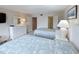 Well-lit bedroom features two comfortable twin beds, a dresser, and a view into the bathroom at 645 Retreat Beach Circle, Pawleys Island, SC 29585