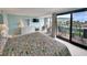 Airy bedroom with a balcony and ocean view, dresser, and television at 645 Retreat Beach Circle, Pawleys Island, SC 29585