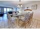 Bright dining room with a glass table, six chairs, and views of the living room and ocean beyond at 645 Retreat Beach Circle, Pawleys Island, SC 29585