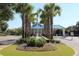 View of a community entrance with a blue roof, a fountain and a stop sign at 645 Retreat Beach Circle, Pawleys Island, SC 29585