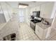 Well-lit galley kitchen features granite countertops, white cabinets, and stainless steel appliances at 645 Retreat Beach Circle, Pawleys Island, SC 29585