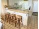 Kitchen breakfast bar features a granite countertop and three woven-seat stools at 645 Retreat Beach Circle, Pawleys Island, SC 29585