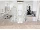 Well-lit kitchen features granite countertops, white cabinets, and stainless steel appliances at 645 Retreat Beach Circle, Pawleys Island, SC 29585