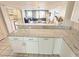Bright kitchenette with a granite countertop that overlooks the dining room and living room at 645 Retreat Beach Circle, Pawleys Island, SC 29585