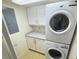 Laundry area with stacked washer and dryer, storage cabinets, and granite countertop at 645 Retreat Beach Circle, Pawleys Island, SC 29585