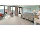 Bright main bedroom boasts balcony access with beautiful beach views, seating, and light blue walls at 645 Retreat Beach Circle, Pawleys Island, SC 29585