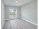 Bright bedroom with wood-look floors and large window at 70 Addison Cottage Way # 319, Murrells Inlet, SC 29576