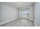 Bright bedroom with large window and wood-look floors at 70 Addison Cottage Way # 319, Murrells Inlet, SC 29576