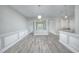 Open dining room with wood-look floors and wainscoting at 70 Addison Cottage Way # 319, Murrells Inlet, SC 29576