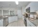Bright kitchen with granite countertops and white cabinets at 70 Addison Cottage Way # 319, Murrells Inlet, SC 29576