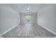 Living room with vaulted ceiling, large window, and wood-look floors at 70 Addison Cottage Way # 319, Murrells Inlet, SC 29576
