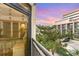 Balcony with an interior view of another room as the sun sets in the background sky at 7100 Ocean Blvd. # 223, Myrtle Beach, SC 29572