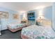 Bright bedroom featuring two beds with blue and white seashell themed bedding and beach artwork at 7100 Ocean Blvd. # 223, Myrtle Beach, SC 29572
