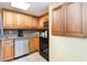 Kitchen with light wood cabinetry, stainless steel dishwasher, and black oven at 7100 Ocean Blvd. # 223, Myrtle Beach, SC 29572