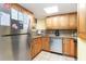 Efficient kitchen with stainless steel appliances, tile backsplash, and wooden cabinets at 7100 Ocean Blvd. # 223, Myrtle Beach, SC 29572