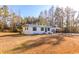 Ranch style home with metal roof, surrounded by mature trees and a spacious yard at 747 Bucksville Dr., Conway, SC 29527