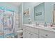Bathroom with white vanity, seashell shower curtain, and a mirror at 747 Coquina Bay Dr., Conway, SC 29526