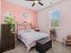 Bright bedroom with pink walls, a metal bed frame, and window coverings at 747 Coquina Bay Dr., Conway, SC 29526
