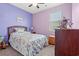 Cozy bedroom with lavender walls, floral bedding, and ample closet space at 747 Coquina Bay Dr., Conway, SC 29526