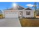 Charming one-story home with a two-car garage and landscaped lawn at 747 Coquina Bay Dr., Conway, SC 29526