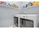 Laundry room with washer, dryer, and shelving for storage at 747 Coquina Bay Dr., Conway, SC 29526