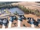 An aerial view of multiple homes situated around a picturesque pond, highlighting the community's appeal at 817 Payne Ct., Conway, SC 29526