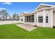 A spacious backyard with healthy green grass, leading to the screened porch and outdoor patio at 817 Payne Ct., Conway, SC 29526