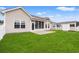 Spacious backyard featuring a well-maintained lawn, outdoor storage, and a view of the exterior of the house at 817 Payne Ct., Conway, SC 29526