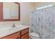 Bathroom with single sink vanity and floral shower curtain at 817 Payne Ct., Conway, SC 29526