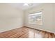 Bedroom with wood-look flooring, ceiling fan, and large window at 817 Payne Ct., Conway, SC 29526