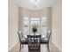 Bright breakfast nook with a bay window overlooking the backyard, complete with a charming round table and four chairs at 817 Payne Ct., Conway, SC 29526