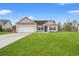 Charming single-story home featuring a well-manicured lawn, attached garage, and blue shutters against a bright blue sky at 817 Payne Ct., Conway, SC 29526