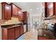 Well-equipped kitchen featuring dark wood cabinetry, granite countertops, stainless steel appliances and view to breakfast nook at 817 Payne Ct., Conway, SC 29526