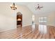 Bright living room with wood floors, vaulted ceilings, kitchen access, and sliding glass doors to the back at 817 Payne Ct., Conway, SC 29526
