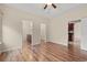 Large main bedroom featuring wood floors, walk-in closet, ensuite bathroom, and an entryway into another living space at 817 Payne Ct., Conway, SC 29526