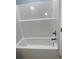 Bathroom with white tub and shower with silver hardware in property at 931 Edge Dr., North Myrtle Beach, SC 29582