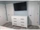 Bright bedroom featuring large television and dresser, offering ample storage at 931 Edge Dr., North Myrtle Beach, SC 29582