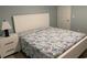 Comfortable bedroom with white bed frame, patterned bedding, and bedside table at 931 Edge Dr., North Myrtle Beach, SC 29582