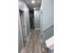 Hallway in property leading to kitchen area with stainless steel refrigerator at 931 Edge Dr., North Myrtle Beach, SC 29582