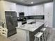 Bright kitchen features white cabinetry, a large island, and stainless steel appliances at 931 Edge Dr., North Myrtle Beach, SC 29582