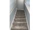 Carpeted staircase with white painted trim and handrail, leading to the upper level at 931 Edge Dr., North Myrtle Beach, SC 29582