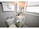 Well-maintained bathroom with white fixtures, ample lighting, and a mirrored cabinet at 9620 Windchime Dr., Myrtle Beach, SC 29572