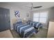 Comfortable bedroom with twin beds, stylish blue bedding, and a modern ceiling fan at 9620 Windchime Dr., Myrtle Beach, SC 29572