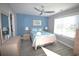Cozy bedroom with bright blue wall, beach-themed bedding, and ceiling fan at 9620 Windchime Dr., Myrtle Beach, SC 29572