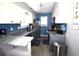 Modern kitchen features white upper cabinets, blue backsplash, and updated appliances at 9620 Windchime Dr., Myrtle Beach, SC 29572