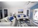 Bright living room with beach decor, ceiling fan, sliding glass door, and comfortable seating arrangement at 9620 Windchime Dr., Myrtle Beach, SC 29572