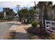 View of the Ocean Green Cottages entrance on a sunny day with clear skies at 9620 Windchime Dr., Myrtle Beach, SC 29572