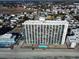Aerial view of high rise building, pool, and beach at 1210 N Waccamaw Dr. # 702, Murrells Inlet, SC 29576